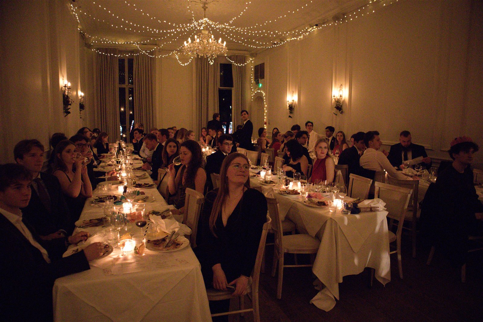 Students seated for the candlelit Christmas Dinner at Ognisko