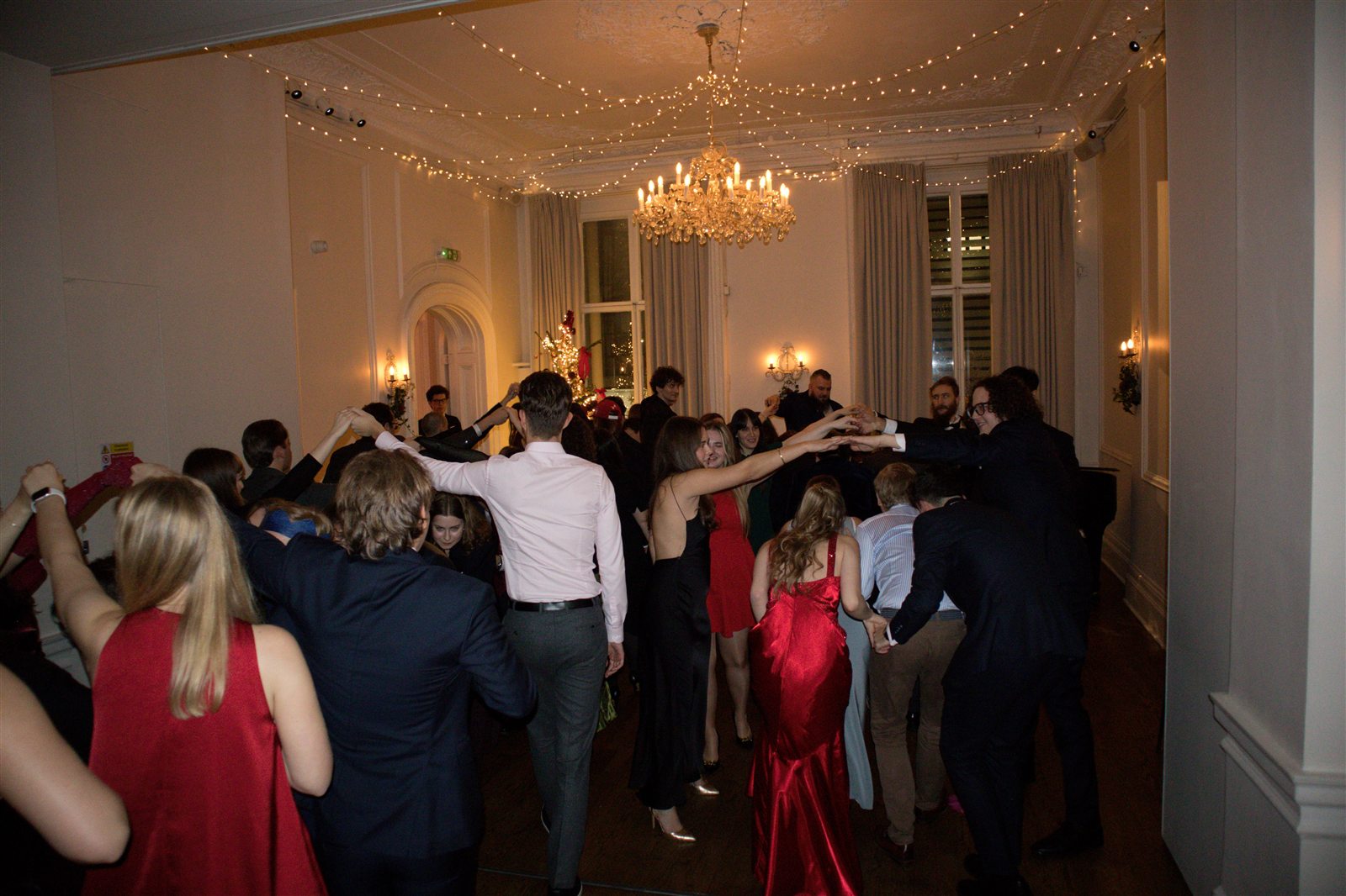 Guests dancing the polonez through the hall